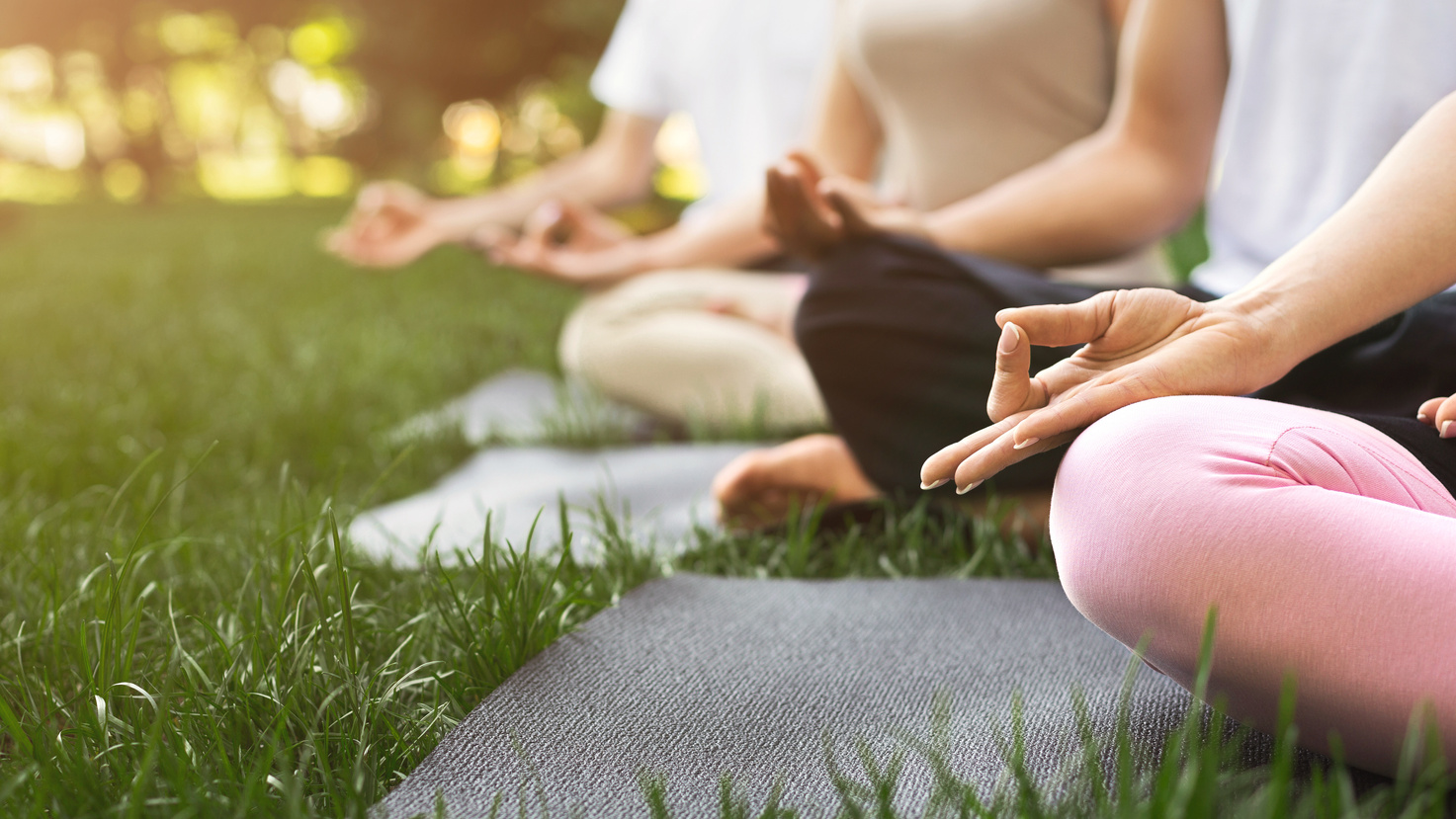 Group of people meditating in park